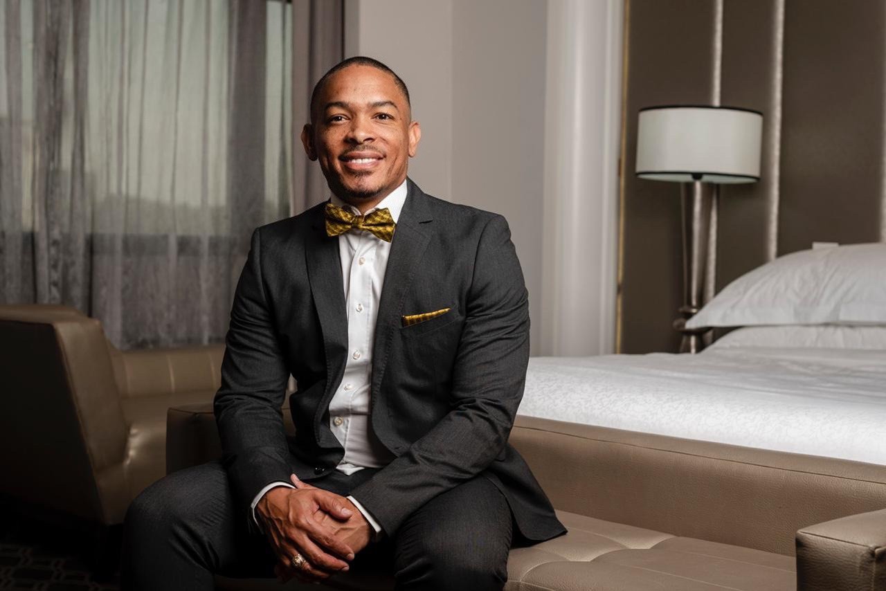Arthur Wade Anderson in a dark suit and gold bow tie